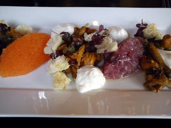 Löjrom served with crème fraîche and red onion