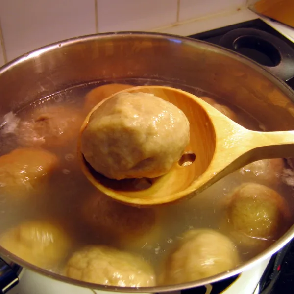 Palt dumplings boiling in a pot