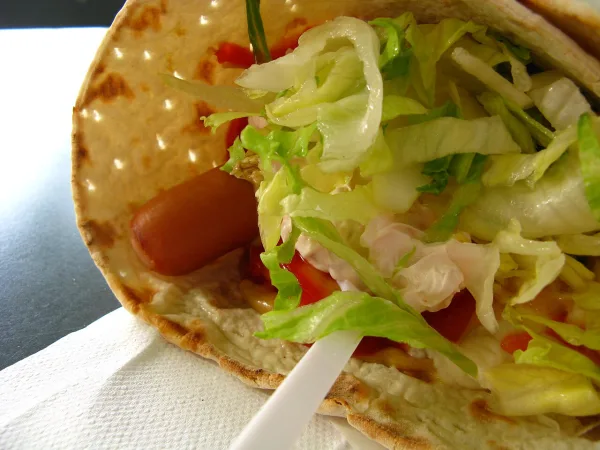 Tunnbrödsrulle with hot dog, shrimp salad, and lettuce in flatbread